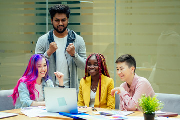 mixed-race journalist fashion designers working together in a bright office