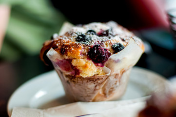 Delisious berry muffin on a plate . Breakfast at the cafe