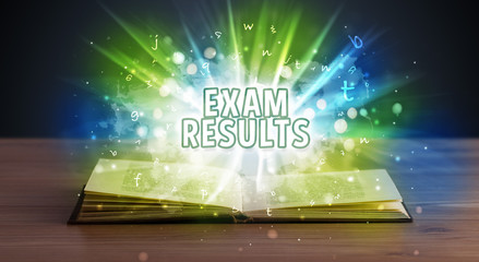 EXAM RESULTS inscription coming out from an open book, educational concept