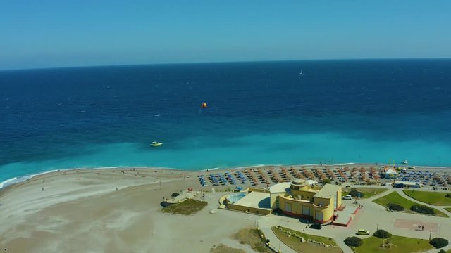 flying on a drone over a beautiful beach with turquoise water and shoreline with hotels of Rhodes Greece Europe. Ellie beach