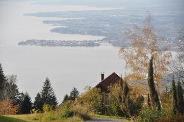the Lake Constance seen from the top of the Pfänder, with a chalet in the foreground and Lindau island (Bavaria, Germany) in the background on an autumn day, Voralberg, Austria