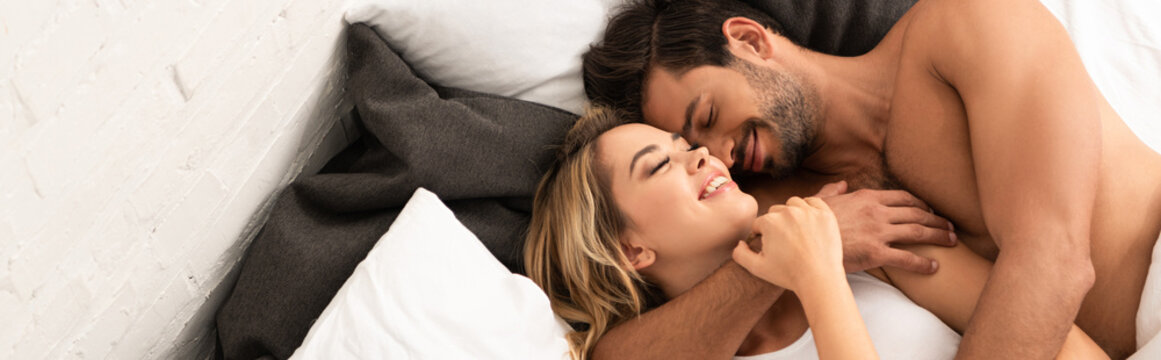 happy tender couple hugging in bed in the morning