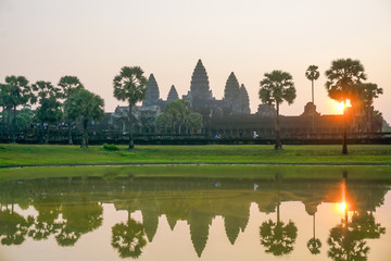 Fototapeta na wymiar Angkor Wat at sunrise in the reflection of the lake