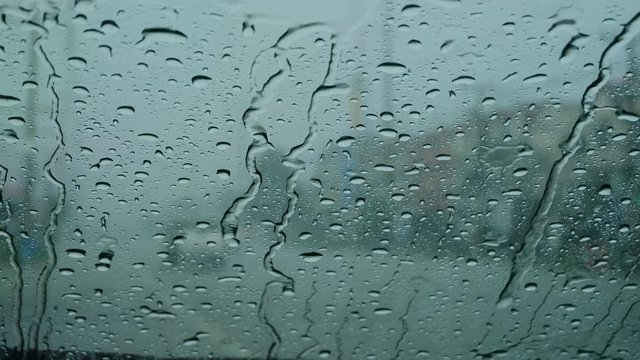 View of country side road from car's front windscreen when in the rain