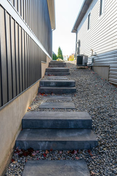 Precast concrete steps provide a safe and comfortable landscaping solution to address the steep grade between two houses.