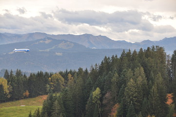 a zeppelin airship flying over the Alps on an autumn day seen from the Pfänder, Voralberg, Austria © SIMONE