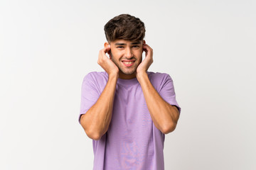 Young handsome man over isolated white background frustrated and covering ears