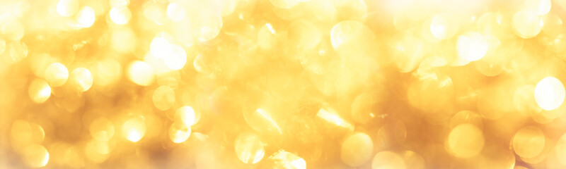 golden color blurred abstract background. yellow bokeh christmas blurred beautiful shiny Christmas...