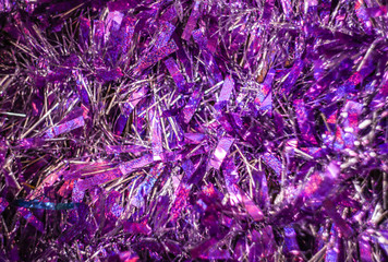 Christmas background, shiny tinsel in purple and white, texture