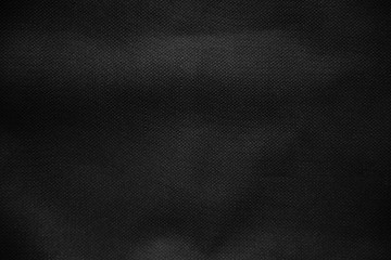 Black canvas pattern background. Surface with spotlight, dark tone.