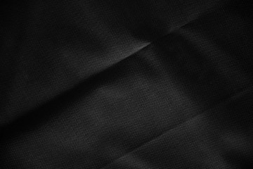 Obraz premium Black canvas pattern background. Surface with spotlight, dark tone.