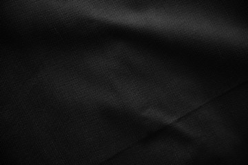 Black canvas pattern background. Surface with spotlight, dark tone.