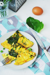 healthy breakfast, egg frittata with spinach, dill, green peas on a light background