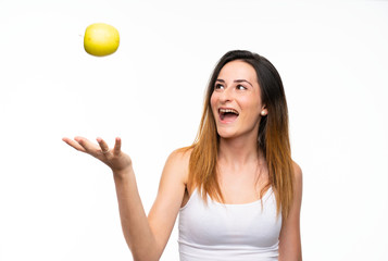 Young woman with an apple over isolated white background