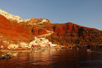 Photo from picturesque fishing harbour and bay of Ammoudi below iconic and famous village of Oia, Santorini island, Cyclades