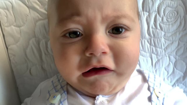 Closeup of baby boy face complaining and upset