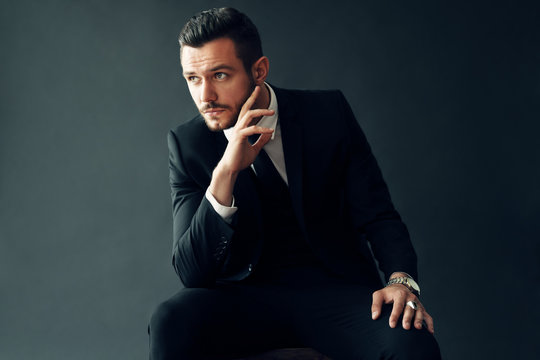 Elegant young man portrait on black background