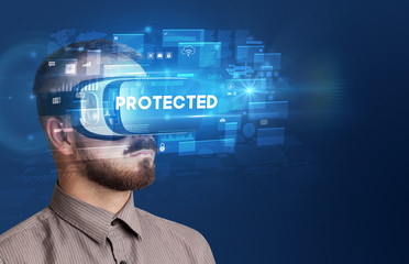 Businessman looking through Virtual Reality glasses with PROTECTED inscription, innovative security concept