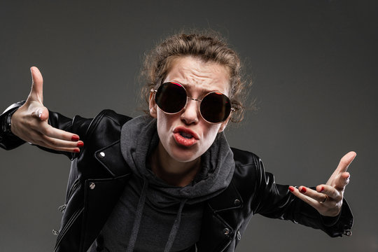 cool punk girl indignantly stretches out her arms towards the camera, emotional portrait