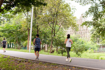 Fototapeta na wymiar Fitness sport woman and man running on the path trail in the park in morning.