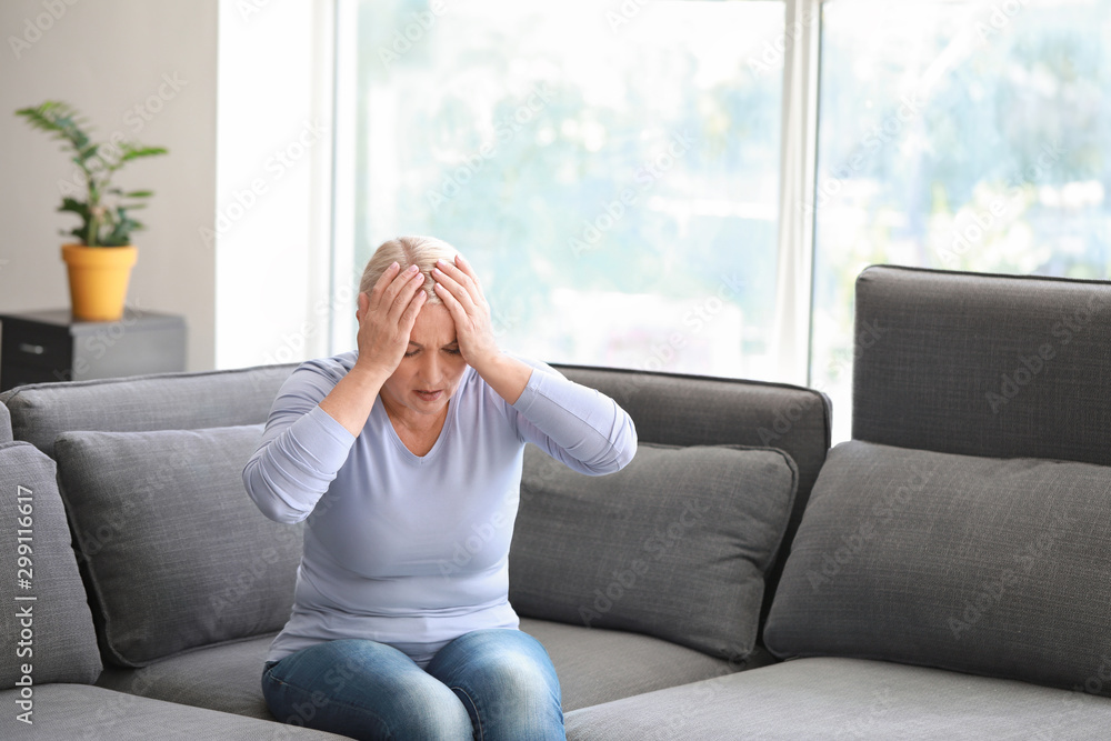 Sticker Mature woman suffering from headache at home