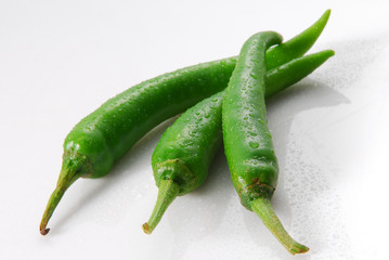 green chili peppers on white background
