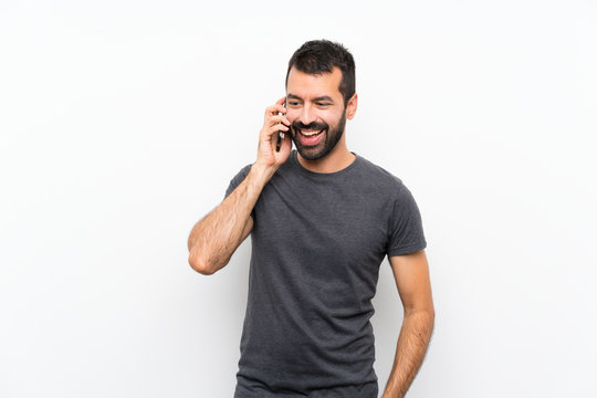 Young Handsome Man Over Isolated White Background Keeping A Conversation With The Mobile Phone