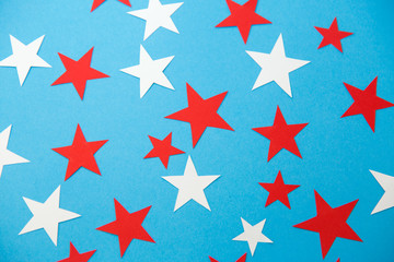 party, celebration and decoration concept - star shaped confetti on blue background