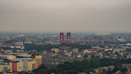 Cityscape of Palembang with Ampera bridge at dusk