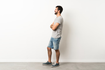 A full-length shot of handsome man with beard in lateral position