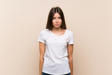 Obraz premium Pretty young girl over isolated background with sad and depressed expression