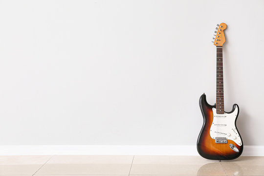 Modern Bass Guitar Near White Wall