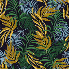 Original seamless tropical pattern with bright green and yellow plants and leaves on a dark background.  Seamless pattern with colorful leaves and plants. Exotic tropics. Summer.