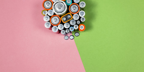 Many different types used or new battery, rechargeable accumulator, alkaline batteries on color...