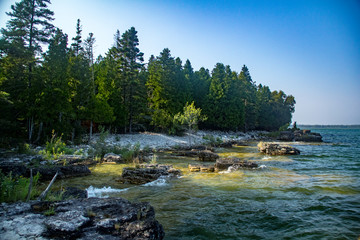 Rocky beach and treeline at Toft Point in Door County, Wisconsin