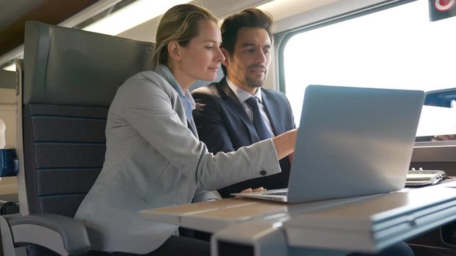 two colleagues working on a train