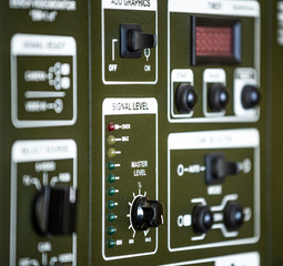 Close-up side view of panel of buttons and twirls