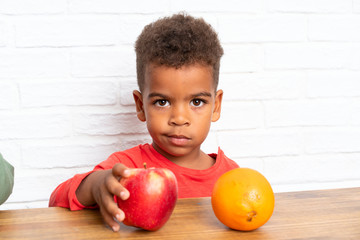 Fototapeta premium African American brothers having breakfast with an apple