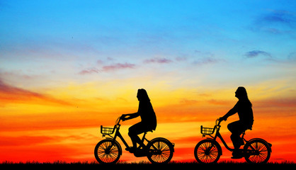 silhouette happy family ride bike on sunrise