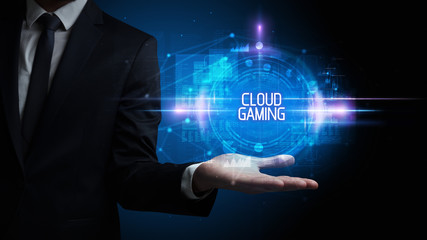 Fototapeta premium Man hand holding CLOUD GAMING inscription, technology concept