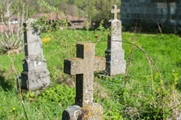 Old tombstones in christian cemetery closeup in church courtyard