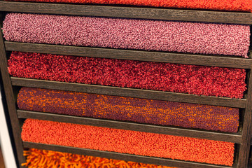 samples of multi-colored carpets on the shelves