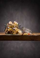 dehydrated fruit in open glass jar on wooden table