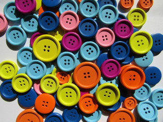 Fototapeta premium The background with many different colorful buttons on the table 
