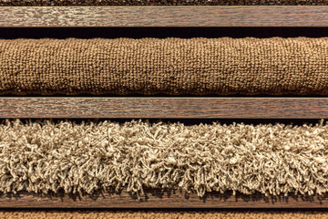 samples of multi-colored carpets on the shelves
