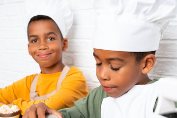 Two African American brothers kids dressed as chef