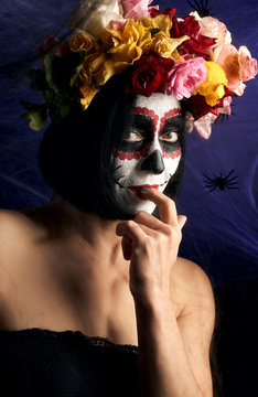 Portrait of a young girl with makeup in the image of Katrina for the holiday of the Day of the Dead. Sugar skull makeup