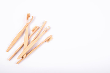 Top view of bamboo toothbrushes isolated on white background. Flat Lay. Zero waste eco life concept. Plastic free. Copy space.