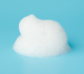 Soap foam bubble isolated on blue background object beatuy health care concept