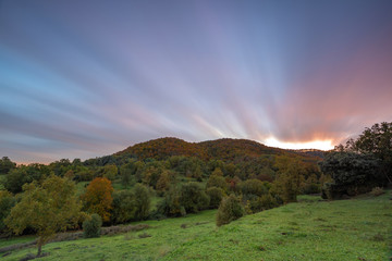 Nice long exposure picture, cloudscape over the mountain in sunset and autumn colors